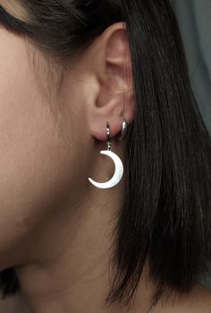 Selena. Shine with the light of the Moon. This unique pair of earrings is composed of rhodium filled huggies and sterling silver crescent moons. Perfect pair to give a witchy vibe to any outfit. Makes a very cute gift! Earring length: 1.2 inches / 3 cm ✺They are sold as a pair✺ ❈ We send all our items with registered mail. ❉ Due to the organic nature of stones, there might be a slight variation in colour, size and shape. ✺ All items come packaged in a quality velvet pouch ready for gift giving. ✽ If you want to make a special order, just contact us! Moon Dangle Earrings, Minimalist Moon Charm Drop Earrings, Dainty Half Moon Charm Earrings, Gothic Crescent Moon Charm Jewelry, Dainty Half Moon Earrings With Moon Charm, Minimalist Moon Shaped Single Earring, Silver Crescent Symbolic Earrings, Symbolic Silver Crescent Earrings, Dainty Single Moon Earring