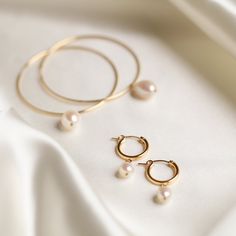 Designer: OFINA An everyday classic. Polished pearl mini hoops to give you a classic modern look. Available in 2 sizes. Small Size: 15mm Hoop w/ 7-8mm Freshwater Pearl Large Size: 18mm Hoop w/ 10mm Freshwater Pearl Material & Care 14k Gold Filled Stone: Freshwater Pearl Hypoallergenic Can be worn in water For more info: Jewelry Care How to Wear Lovely alone or stack the two sizes together. Can also be paired with your favorite huggies and studs! Free Shipping & Repairs within 30 days Formal Minimalist Hoop Pearl Earrings, Classic Pearl Huggie Jewelry, Minimalist Hoop Pearl Earrings For Formal Occasions, Classic Pearl White Hoop Earrings, Classic Small Hoop Pearl Jewelry, Classic Pearl White Pearl Hoop Earrings, Classic Pearl Hoop Jewelry, Minimalist Pearl Drop Hoop Earrings For Anniversary, Classic Pearl Huggie Earrings Small Hoop