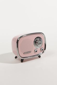 a pink radio sitting on top of a white table