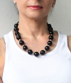 "This black onyx statement beaded necklace is an elegant combination. It gives this necklace its rich, sophisticated look. I hand selected high quality black onyx 14mm round gemstones, and set each stone with small 3mm sterling silver beads for a classic elegant look. The black onyx gemstones are separated by small silver-plated beads in this lovely necklace while a silver lobster clasp completes the design.  This single strand onyx necklace will go with everything in your wardrobe.  It is a stu Elegant Black Beaded Necklaces With Polished Beads, Elegant Black Beaded Necklace With Polished Beads, Elegant Formal Beaded Necklaces With Large Beads, Elegant Formal Beaded Necklace With Large Beads, Classic Black Beaded Necklaces With Polished Beads, Elegant Black Beaded Necklaces With Gemstone Beads, Formal Black Necklace With Gemstone Beads, Elegant Black Beaded Necklace With Gemstone Beads, Formal Onyx Beaded Necklaces With Polished Beads