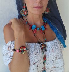 Painted Set Necklace Bracelet Earrings inspired by Ancient Greek Minoan Art (palace of Knossos). Boho Blue Red  Brown Jewelry Set Gift with Semi-Precious stone. Knossos is the largest Bronze Age archaeological site on Crete and has been called Europe's oldest city. Settled as early as the Neolithic period, the name Knossos survives from ancient Greek references to the major city of Crete. The palace of Knossos eventually became the ceremonial and political centre of the Minoan civilization and culture. The palace was abandoned at some unknown time at the end of the Late Bronze Age, c. 1,380-1,100 BC. The reason why is unknown, but one of the many disasters that befell the palace is generally put forward. Material used   1. Earrings   acrylic paint, wooden earrings, blue jade, red ceramic b Artisan Adjustable Jewelry For Festivals, Bohemian Multicolor Decorative Jewelry, Bohemian Decorative Jewelry For Gifts, Adjustable Turquoise Bohemian Jewelry Sets, Handmade Adjustable Red Jewelry Sets, Adjustable Handmade Red Jewelry Sets, Bohemian Adjustable Decorative Jewelry, Adjustable Round Multicolor Jewelry Sets, Bohemian Jewelry With Unique Variations For Festivals