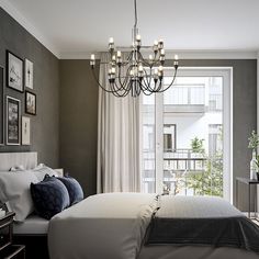 a bedroom with a chandelier hanging from the ceiling