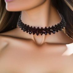 This Black Crystal Choker is a exquisite accessory is a fusion of elegance and mystique, designed to adorn your neckline with a touch of dark sophistication. Crafted meticulously, the choker comprises two layers of meticulously arranged black crystal rondelles, each 4mm and 6mm in size. These crystals have been carefully selected to create a mesmerizing play of light and shadows, ensuring that the choker sparkles with every subtle movement you make. The moment you shift, the choker comes alive w Adjustable Gothic Choker For Costume Party, Adjustable Black Choker For Costume Party, Witchy Black Choker For Gift, Gothic Choker Jewelry For Party, Gothic Choker For Parties, Black Vampire Jewelry For Festival, Gothic Black Choker For Evening, Black Gothic Choker For Evening Wear, Vampire Style Black Jewelry For Festivals