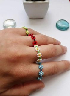 Beautiful,Colorful,Cute,Stackable Rings Make your day more colorful with some of my items. Each one of them is handmade with a lot of love and positive energy. Handmade rings with flowers, where you can choose the color of the flower, the stamen and the band. Depending on where you are viewing the item on a mobile device or monitor, colors may have a slight discrepancy. If you have questions or ideas, do not hesitate to ask them. Thank you for visiting my store! For more great jewelry you can visit this link  https://www.etsy.com/shop/NataliaArttCo?ref=seller-platform-mcnav Rings With Flowers, Rings Beaded, Beaded Diy, Surf Bracelet, Kabbalah Bracelet, 4 Friends, Beads Ring, Flower Rings, Crafts Videos