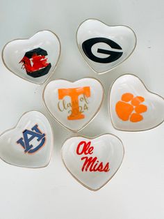 Custom University college logo ring jewelry trinket dish.  Handmade logo on ceramic heart dish with hand gold painted rim.  Great unique gift for any college student or alumni. Perfect for graduation / college acceptance gifts.  Size: 8 X 8 cm / 3 X 3 inches Material: High-fired ceramic arrives gift boxed with ribbon and logo as shown Can be personalized with name or date for additional charge  Personalize - school of choice + color  Dont see your school -  give me the details in the personalization section  Please keep in mind that each peice is handcrafted and unique. Best Friend Going To College Gift, College Dorm Diy Decor, College Merchandise Ideas, Custom Gifts For Friends, Customized Graduation Gifts, College Senior Gift Ideas, Grad Gift For Best Friend, Senior Gifts For Friends, Diy Customized Gifts