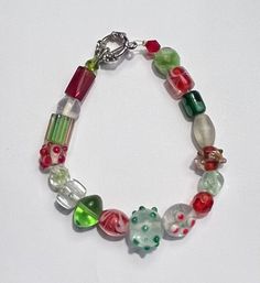 Christmas Beaded Bracelet 8" Length Toggle Closure Lightweight  Various Different Sized Beads Ships USPS First Class Mail Handmade Multicolor Beaded Bracelets For Holidays, Green Beaded Bracelet For Holiday, Handmade Green Beaded Bracelets For Holidays, Christmas Multicolor Beaded Bracelets, Colorful Round Beaded Bracelets For Holiday, Colorful Round Beads Bracelets For Holiday, Bohemian Beaded Bracelets With Round Beads For Holiday, Holiday Bracelets With Colorful Round Beads, Holiday Handmade Beaded Bracelets With Round Beads