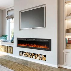 a living room with a television mounted on the wall and fire place in front of it