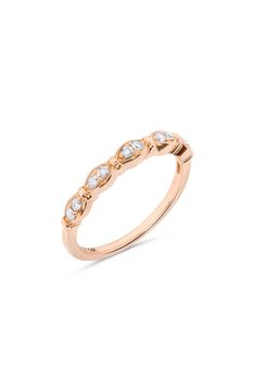 a rose gold ring with five diamonds