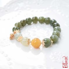 The bracelet selects natural Hetian nephrite jade beads with a round-barrel shape and green tone. Wearing jade jewelry for a long time will be beneficial to your body and make jade oily and bright. Round ornament represents completeness and happiness in Chinese culture. Therefore, ancient women were keen to wear bracelets to express their hope for a better life. Today, a piece of bangle still highlights the slenderness of the wrist, adding a woman's gentle temperament. It will bring you more coo Green Agate Hand-strung Crystal Bracelet, Green Agate Crystal Bracelet With Gemstone Beads, Green Agate Round Crystal Bracelet, Green Jade Gemstone Beads Bracelets, Green Jade Beaded Bracelets With Polished Beads, Green Hand-strung Jade Bracelets, Green Jade Bracelets With Round Beads, Hand-strung Green Jade Bracelets, Green Jade Gemstone Beaded Bracelets