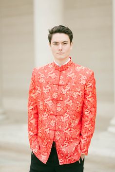 "A minimalist modern Chinese wedding jacket made of sleek red fabric and adorned with golden pankou buttons. This changshan is the male equivalent of the classic red cheongsam. Its vibrant red is perfect for a wedding celebration. Matches well with any of our red wedding cheongsams (qipaos). Check out our other jackets and changshans at www.eastmeetsdress.com. The Details: * Mandarin collar with frog buttons * Made of satin fabric * Breathable, comfortable formal wear * Full inner lining Sizing: Chinese Wedding Outfits, Wedding Groom Outfit, Chinese Suit, Modern Chinese Wedding, Red Cheongsam, Wedding Cheongsam, Wedding Jacket, Wedding Reception Dress, Qipao Dress