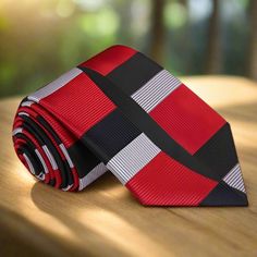 Each tie is hand stitched and made from 100% silk. Choose from one of unforgettable colorways. Wear this amazing looking necktie with a black suit and pair it with an accenting pocket square. Choose From: Single Tie Tie, Pocket Square Material of Tie and Pocket Square: 100% Silk Width of Tie: 3.4” Inches Pattern: Abstract Color Of Necktie: Red, Black, Grey Gold, Black, Grey Red, Black, Grey Dapper Red Tie For Semi-formal Occasions, Dapper Semi-formal Red Tie, Dapper Ties With Pocket Square For Black Tie Events, Black Tie And Pocket Square Set, Dapper Red Suit And Tie Accessories For Formal Occasions, Dapper Red Suit And Tie Accessories For Formal Events, Black Tie With Pocket Square For Black-tie Events, Red Ties For Black-tie Events, Red Tie With Pocket Square For Black Tie Event