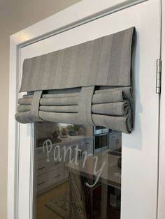 a window with some curtains on it and the words pantry written in front of it