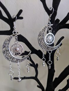 A gorgeous pair of earrings featuring earth's surrounding celestial bodies: the moon, the sun, and the stars. Choose between silver as pictured or bronze! Celestial Style Nickel-free Metal Hoop Earrings, Celestial Style Silver Metal Jewelry, Celestial Metal Hoop Earrings, Celestial Metal Hoop Earrings Nickel Free, Nickel Free Celestial Metal Hoop Earrings, Celestial Style Metal Hoop Earrings Nickel Free, Celestial Style Nickel Free Metal Hoop Earrings, Silver Crescent Symbolic Earrings, Adjustable Silver Celestial Hoop Earrings