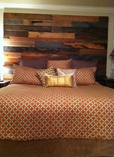 a bed with wooden headboard and pillows on top of it next to two lamps