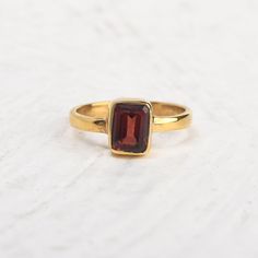 Simple 14k gold vermeil promise ring with single red garnet stone. Tiny stackable everyday ring, January birthstone ring, wedding anniversary ring, gift for the sweetheart. Specifications :--- ✔️ Made to Order ✔️ Metal Options ~ 14K Gold Vermeil  ✔️ Gemstone : Garnet ✔️ Gemstone Size : 6mm x 8mm ✔️ Handmade Jewelry ❤ Everything in my shop is handmade. ❤❤ Each item will be beautifully packed in a recycled box.  I happily take all customized orders. Q: What is 14k gold vermeil? A. Gold vermeil is a type of gold jewelry made to last. The base metal is Sterling Silver which means your piece is made from precious metals only. A thick layer of gold is then electroplated over the base metal. While it may sound similar to gold plated jewelry, gold vermeil jewelry has a much thicker layer of gold. Classic Gold Stackable Ruby Ring, Classic Ruby Stackable Rings As A Gift, Classic Ruby Stackable Rings For Gift, Classic Stackable Ruby Ring Gift, Gold Stackable Ruby Birthstone Ring, Garnet Stackable Rings As A Gift, Stackable Gold Ruby Ring For Gift, Gold Garnet Birthstone Ring Gift, Wine Ring