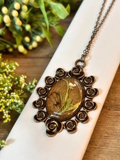 A handmade, one-of-a-kind antique bronze pendant necklace with cicada wings and flora preserved in resin. Matching chain included. Cicada Wings, Bronze Frame, Flower Pendant Necklace, Bronze Pendant, Flower Pendant, Antique Bronze, Necklace Set, Favorite Jewelry, Jewelry Necklace Pendant