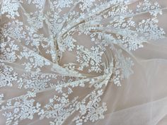 the fabric has white flowers on it and is very soft, sheer - knited