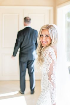 a woman in a wedding dress standing next to a man