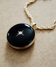 The North Star is an anchor, holding nearly still while the entire northern sky moves around it. This Gold Filled locket is a beautiful reminder, and can hold close what serves as your anchor, your ever constant guide through this life. Enameled in the color of your choice. (Sample shown in Black #28) ITEM DETAILS * Large round 14K Gold Filled locket measures 20 mm * Enameled in the color of your choice * Gold North Star detailed on the front of locket * Photo inserts on both inside areas of the Unique Locket Necklace, Black Locket, Vintage Locket Necklace, Unique Locket, Star Photo, The North Star, Round Locket, Photo Locket Necklace, Vintage Lockets