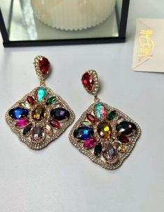 Multi-Colored Crystal Stone Earrings Super fun and glam, colorful earrings that offer Crystal stones of different colors. Be the star of the show with these flashy beauties! -Lightweight -High Quality -Durable -Nickel and Lead Free Scene Earrings, Instagram Party, Party Scene, Crystal Stones, Colorful Earrings, Gold Collection, Crystal Stone, Ring Collections, Color Crystal