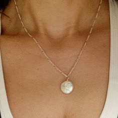 Pearls are timeless, and this flat freshwater coin pearl is no exception! Hung solitaire on a 925-sterling silver chain, it's easy to wear to the beach or to a wedding. The perfect everyday piece!  This pearl necklace is a handmade item. Due to the natural variation and uniqueness of pearl. All pearl pendants will vary from piece to piece. Please note that there will be a slight difference in size, color, and inclusion within the stone. Measurements: 925 silver chain length: 18 inches/ 45 cm fre Simple Silver Jewelry With Pearl Charm, Simple Silver Jewelry With Pearl Chain, Simple Silver Pearl Drop Jewelry, Delicate Silver Charm Necklace With Pearl, Dainty Silver Charm Necklaces With Pearl Pendant, Elegant Pearl Necklace With Coin Pendant, Silver Minimalist Charm Necklace With Pearl Chain, Dainty Silver Charm Necklace With Pearl Drop, Minimalist Silver Pearl Charm Necklace