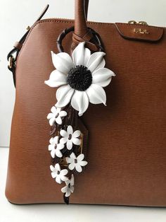 "These beautiful Flower leather Purse charm & keychain are carefully handcrafted. Flower Size: around 2.75 \" to 3\" approx Length from top to bottom: around 8.5-9\" approx (including the ring) All items are made and ship from Southern California. For what's new , specials and upcoming events Follow us Facebook page : Leather E Instagram: flowerbyleathere" Couture, Diy Leather Flowers, Boho Tassel Keychain, Purse Charms Diy, Leather Handbag Patterns, Leather Making, Real Leather Bags, Diy Bag Designs, Drawing Bag