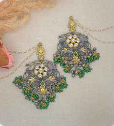 Oxidized statement earrings with pachi kundan work with light sahara(chain).  Dimensions-  Earrings length- 4.5 inches ,  width- 2.2 inches, Chain length- 7 inches Style tip- Pair it with any beautiful traditional outfits  and flaunt with Unique style of collection from us. Perfect match for Festival and Traditional wear.  Take Care Tips-  Kee away from perfume, Hair spray and. Moisture.  Store in dry place , Ziplock bag or Airtight box.    Clean with dry cloth.  Jewellery is the last thing you Festive Brass Chandelier Earrings In Temple Jewelry Style, Festive Brass Temple Jewelry Chandelier Earrings, Fusion Kundan Necklace With Latkans, Fusion Style Kundan Danglers For Festive Occasions, Fusion Style Kundan Necklace With Latkans, Festive Fusion Kundan Danglers, Temple Jewelry Metal Earrings With Tilla, Fusion Kundan Chandelier Earrings With Latkans, Temple Jewelry Metal Chandbalis For Celebration