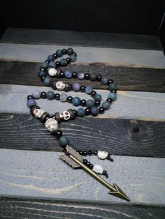 This is a beautiful re-imagined rosary based on the classic Catholic rosary. The beads are matte finish fancy jasper and the spacing beads howlite skulls. There are three decades of nine beads each. The center is a large howlite skull, and I have capped it off with Artemis's arrow and hematite and howlite dangles. With this rosary I'm including a simple chant which has resonated with me, but feel free to use your own! Pagan/witch prayer chant: Knot one, the work's begun. Knot two, my aim is true Bohemian Hand-strung Healing Rosary, Bohemian Hand-strung Rosary For Healing, Adjustable 8mm Beads Rosary For Healing, Spiritual Beaded Rosary For Jewelry Making, Bohemian Rosary With 108 Beads For Healing, Spiritual Gemstone Beads Rosary, Handmade Spiritual Healing Rosary, Adjustable Hand-strung Healing Rosary, Spiritual Rosary With 8mm Beads