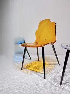 two yellow chairs sitting next to each other on top of a white carpeted floor