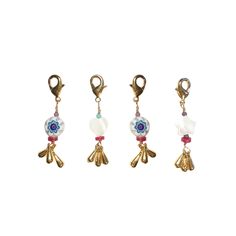 three charms with flowers and beads hanging from them on a white background, each one has a charm in the shape of a flower