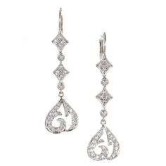 Doris Panos 18k white gold dangle earrings with secure wire tops and a long dramatic design with sparkly diamonds 60 round full cut diamonds, approx. total weight .70cts, F, VS2 18k White Gold Tested: 18k Stamped: 750 Hallmark: DP 2004 5.7 grams Top to bottom: 47.28mm or 1.86 inches Width: 12.72mm at bottom Depth: 2.07mm Gold Dangle Earrings, Drop Dangle Earrings, Diamond Gold, Gold Earrings Dangle, White Diamond, Diamond White, Diamond Jewelry, Gold Diamond, Jewelry Earrings Dangle