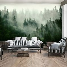 a living room filled with furniture next to a forest wall mural