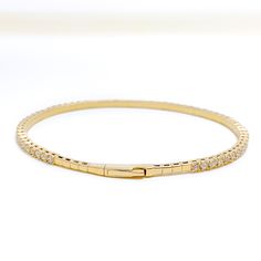 Indulge in the ultimate luxury with our Classy Striking Diamond Bangle Bracelet. Crafted with 18k Yellow Gold and adorned with 1.93ct round brilliant cut diamonds in F-G color and VS quality, this bangle bracelet is a timeless piece that will elevate any outfit. With a weight of 8.1 grams, it features a push lock that makes it easy to wear and take off. Add this exquisite piece to your jewelry collection today. PRODUCT DETAILS Gold Purity(karat): 18k Item Weight(grams): 8.1 Item Finish: Yellow G Yellow Gold Diamond Bracelets With Prong Setting, Fine Jewelry Gold Diamond Bracelet Vvs Clarity, Everyday Luxury Diamond Bangle, Luxury Gold Bangle Bracelet With Brilliant Cut, Yellow Gold Diamond Bangle With Brilliant Cut, Timeless Yellow Gold Bangle With Cubic Zirconia, Timeless Yellow Gold Cubic Zirconia Bangle, Dazzling Yellow Gold Bracelet With Brilliant Cut, Timeless Everyday Luxury Bangle With Brilliant Cut