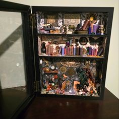 an open book case with many items on it