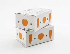 two boxes are stacked on top of each other, with oranges painted on them