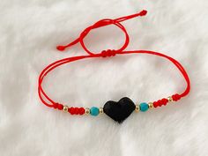 "Red String Azabache Bracelet Beautiful and dainty bracelet with a protection amulet stone (azabache) ideal to keep yourself protected from evil eye, envy and negative vibes or energies. It's made with red cotton cord, turquoise beads and gold filled balls. MATERIALS AND SIZE: Adjustable 5.5\" up to 8.5\" Jet stone/azabache Heart dimension: 1.1cm If you have questions about the product, feel free to reach me out. Don't forget to check out my other items in the store: Https://www.etsy.com/shop/ny Handmade Black Friendship Bracelets For Valentine's Day, Handmade Black Bracelets For Valentine's Day, Handmade Black Bracelet For Valentine's Day, Adjustable Black Heart Bracelet As Gift, Adjustable Black Heart Bracelet For Gifts, Black Heart Bracelets With Heart Charm, Black Heart Bracelet With Heart Charm, Black Heart Beads Bracelet For Gift, Black Bracelet With Heart Charm