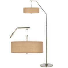 a floor lamp with a beige shade on the bottom and a silver pole underneath it