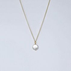 MVP's best selling necklace features a large iridescent coin pearl on a 14k gold filled rope. It's simple, striking, and makes a great gift. Materials 12-14 mm round white freshwater coin pearl with undertones of champagne, ivory and pink; 14k gold-filled chain, magnetic clasp.Size18" All jewelry is handmade by me in my Florida home studio. Orders ship free, and arrive gift wrapped and ready for giving. Please allow 1-3 business days for production. Elegant Hammered Medallion Necklace Gift, Elegant Hammered Medallion Necklace As Gift, Elegant Hammered Round Medallion Necklace, Elegant Hammered Medallion Necklace, Elegant Adjustable Round Medallion Necklace, Elegant Round Medallion Necklace, Gold Pearl Round Pendant Charm Necklaces, Gold Pearl Charm Necklaces With Round Pendant, Gold Pearl Jewelry With Coin Pendant