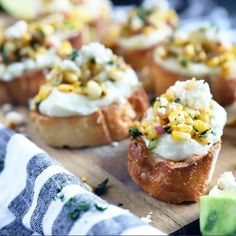 small appetizers are sitting on a cutting board