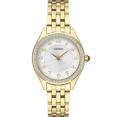 This women's timepiece has a quartz movement and has a round 29MM case. The case and bracelet have a yellow gold-tone and the dial is silver. The bezel is set with Swarovski crystals. Classic Diamond Chronograph Watch For Anniversary, Classic Round Diamond Analog Watch, Classic Analog Diamond Watch, Timeless Diamond Watch For Anniversary, Timeless Diamond Watch With Metal Dial For Anniversary, Formal Yellow Gold Diamond Watch With Chronograph, Formal Yellow Gold Diamond Chronograph Watch, Timeless Chronograph Jewelry For Anniversary, Yellow Gold Diamond Watch With Chronograph