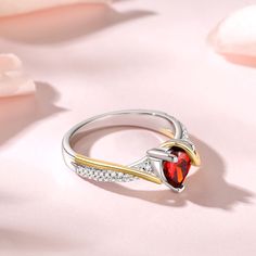 The eternity of love is transformed into a red heart-shaped main stone that blossoms on your fingertips. The golden lines wrap gently around the ring, wrapping love as gently as time. The sterling silver band is serene and elegant, carrying precious emotions. This ring is not only a gorgeous accessory, but also a testimony of love and commitment. Let it witness the best moments in your hearts and embrace the sincerity and warmth forever.Carat Weight: 2.55 ctStone Size: 7*7 mmStone Type: Jeulia® Heart Cut Ring, Best Moments, Red Stone, Sterling Silver Bands, Sterling Silver Heart, Red Garnet, Silver Heart, Silver Band, Red Heart