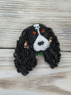 a beaded black and white dog with red eyes