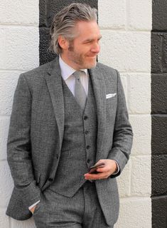 Tailored in a classic gray hue, the Vintage Glasgow Gray Tweed jacket is one of a kind that will hold eternal relevance in any jacket repertoire. Crafted from wool, the famous tweed is hard-wearing and warm and considered as an ideal fabric for dissipating the damp and cold weather. Pair it with a matching waistcoat and trousers, a white shirt, black shoes and a navy silk tie for an elegant formal look. 
 
Look Includes   Vintage Glasgow Gray Tweed Fabric  Two Button Jacket Style  Notch Lapel  S Dark Tweed Suit, Gray Tweed Suit, Welted Pocket, Navy Slim Fit Suit, Brown Tweed Suit, Grey Tweed Suit, White Linen Suit, Green Velvet Jacket, Royal Blue Suit