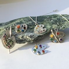 a group of jewelry sitting on top of a rock