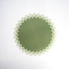 a green circle with white circles in the middle on a gray sky background, as seen from below