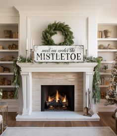 a fireplace with a sign that says meet me next to the mistletoe