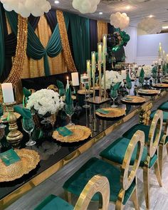 a long table with green chairs and gold plates