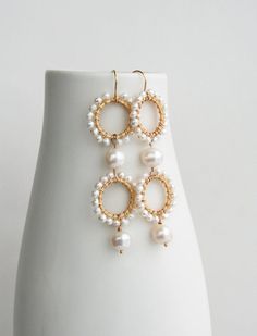 ★★★A modern take on pearls while also keeping it traditional. I've mixed small and large pearls for a unique look. These statement earrings will be a showstopper on your wedding day.+ Freshwater Pearls. 14K Gold Fill Ear Wire. 14K Gold Plate Circles.+ Length: 2.75 inches.+ Earrings take 1 business day to make.+ Your jewelry will come in a jewelry box, tied with a ribbon.➤➤ Have a question about this product, reach out to me here ➙ https://www.etsy.com/conversations/new?with_id=9057464&referr Pearl White Akoya Pearl Earrings With Pearl Chain, Pearl White Akoya Pearl Chain Earrings, White Pearl Embellished Hoop Earrings For Wedding, Elegant Pearl Drop Earrings With Round Beads, Pearl White Akoya Pearl Drop Bridal Earrings, Elegant Hoop Earrings With Pearl Drop, Elegant Handmade Hoop Earrings With Round Beads, Handmade Elegant Round Hoop Earrings, White Round Pearl Pendant Earrings