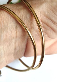 Bangle bracelet, gold bangle bracelet for women, gold bracelet, minimalist bracelet, basic bangle, stacking bracelets, simple gold bracelets A minimalist, gold bangle bracelet, simple but chic, created from a 2.5mm wire which was soldered and plated with nickel free, 14k gold plating. The bangle can be worn by itself or stacked together with similar or different bangles in my shop. These stacking bangle bracelets are a perfect gift for teens and women. Dimensions: The gold bangle bracelet is 2.5mm thick (0.1 inches) and is available in 3 different sizes: Small (S), Medium (M) and Large (L). Small - diameter of 6 cm (or 2.35 inches) Medium - diameter of 6.3 cm (or 2.5 inches) Large - diameter of 7 cm (or 2.75 inches)  Can be made in different sizes upon request. Just convo me for pricing. T Gold Hoop Bangle In Minimalist Style, Gold Bangle Bracelet With Simple Design, Minimalist Gold Hoop Bangle, Minimalist Gold Hoop Bracelet, Gold Simple Design Bangle Bracelet, Minimalist Yellow Gold Brass Bangle, Minimalist Gold Stackable Hoop Earrings, Minimalist Yellow Gold Hoop Bracelet, Minimalist Hoop Bangle In Yellow Gold