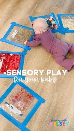 a baby laying on the floor playing with toys